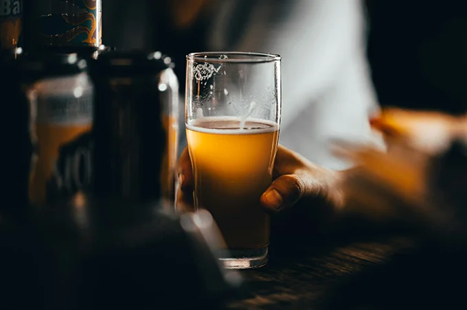 glass half filled with craft beer