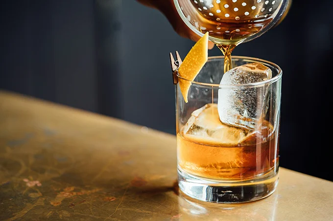 glass of liquor with orange peel
