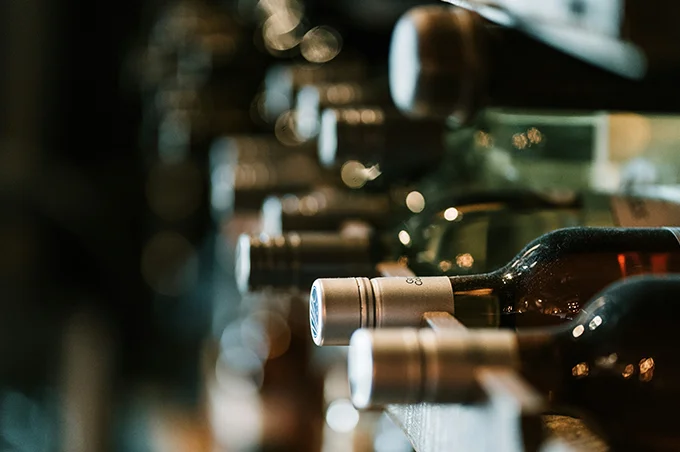 bottles of wine on wooden rack